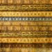 Antique rulers and measuring tapes lie horizontally across the image.