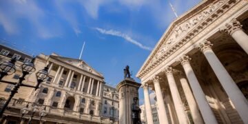 Low angle view of the main facades of the Bank of England and London Stock Exchange and the London Troops memorial at Bank Junction in the City of London. London.
