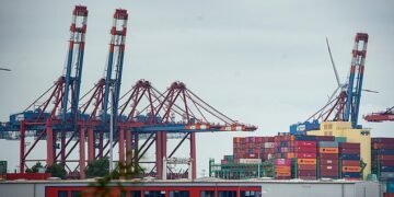 Slump: Shipping containers awaiting transit at Hamburg Port, Germany. Germany's federal statistics office said exports fell 0.9% in July as global demand continued to falter