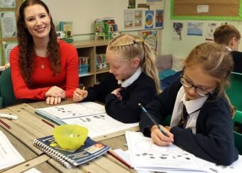 Focused: Adele Cooke joins Year Five pupils for their class learning about debt at St Mary's in Chorley