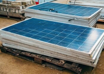 Old solar panels in factory yard.