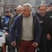 Calin Georgescu, is escorted by police officers inside the prosecutor’s office