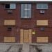An apartment complex with boarded up windows