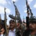 Houthi supporters shout slogans and hold up their weapons during a protest against the US in Sana’a, Yemen on April 25