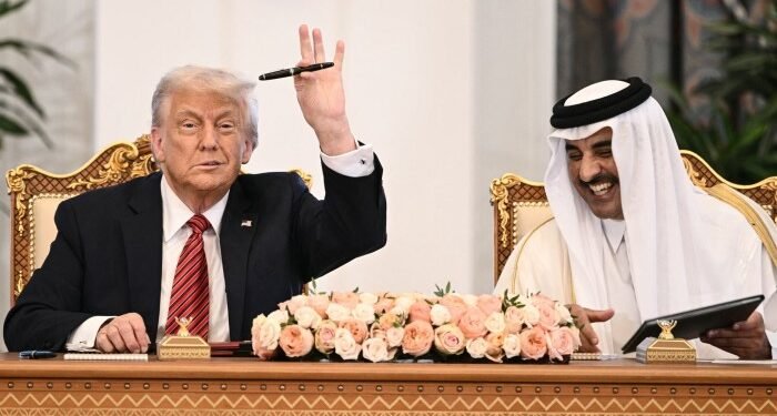 US President Donald Trump, left, and Qatar’s emir Sheikh Tamim bin Hamad al-Thani take part in a signing ceremony at the Royal Palace in Doha on May 14 2025
