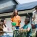 Family at table outdoors near home with solar panels