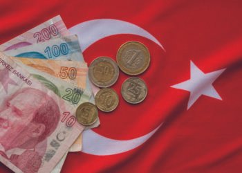 Close-up of Turkish Lira on Turkish Flag.