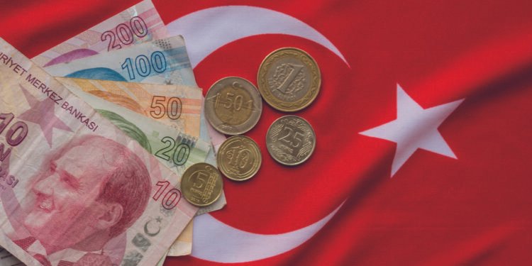 Close-up of Turkish Lira on Turkish Flag.