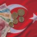 Close-up of Turkish Lira on Turkish Flag.