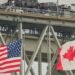A truck with vehicles crosses the Blue Water Bridge border crossing into the US from Sarnia, Ontario, Canada