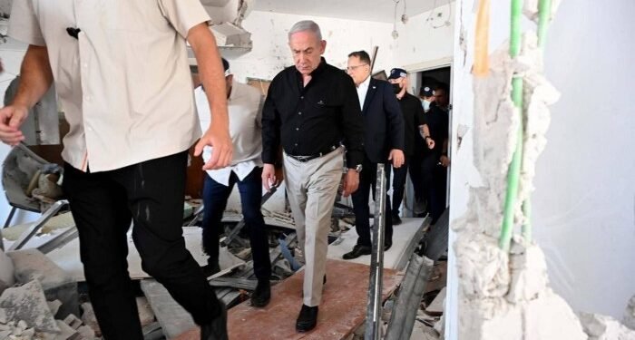 Israeli Prime Minister Benjamin Netanyahu inspects demolished apartment buildings following Iran’s missile attack in Bat Yam on Sunday