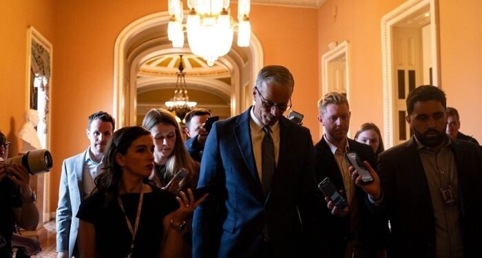 Senate Majority leader John Thune, centre, returns to his office from the Senate chamber in Washington on June 30 2025