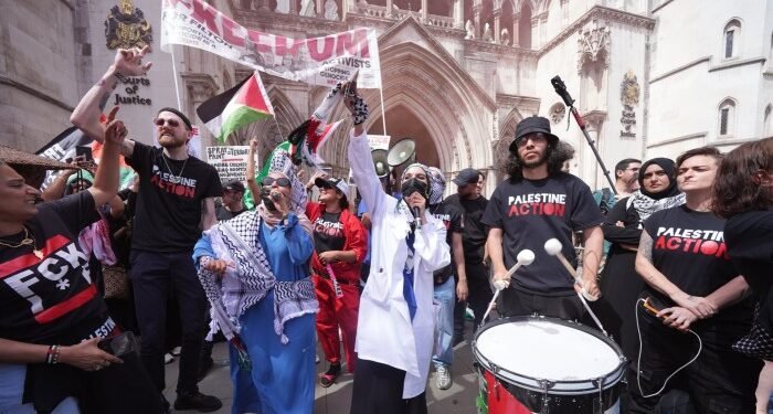 Protesters outside the Royal Courts of Justice on The Strand, central London, ahead of a hearing over whether proscribing of Palestine Action should be temporarily blocked