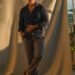 andrew wearing a blue linen shirt, stone chinos, brown loafers, a watch and sunglasses