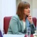 Rachel Reeves sits at a dinner table, resting her chin on her hand and listening attentively.