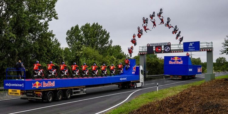 This is the moment a daredevil motocross rider jumps between two moving trucks, not only backflipping between the HGVs but also clearing a motorway gantry at the same time. But the 'meticulously planned' trick stunt doesn't go entirely to plan...