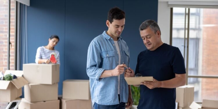 Man in home talking to moving company employee.