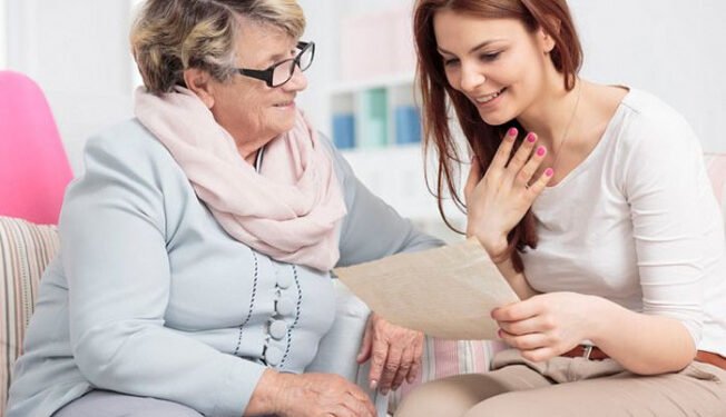 Shot of a young woman reading an old letter and her mother looking at her