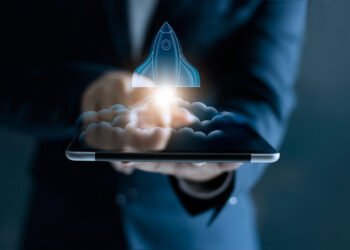 Startup concept, transparent rocket is launching and flying out of tablet on screen