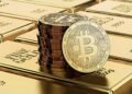 Picture of bitcoins sitting on top of a stack of gold bricks