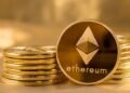 Picture of ethereum coins staked together with one coin stood next to them