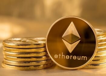 Picture of ethereum coins staked together with one coin stood next to them