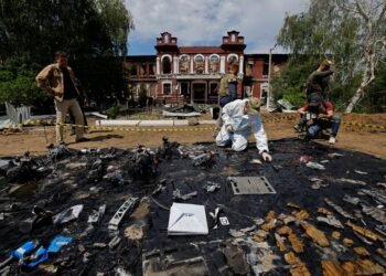 Forensic experts sift through ruined dormitory in Russian-held Luhansk region