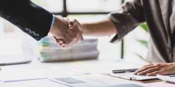 Handshake, Business cooperation at a meeting of business people. Business partners shaking hands in a meeting.