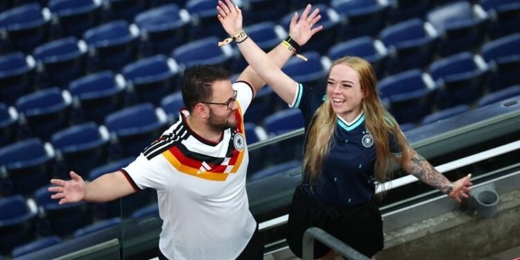 Rain sends Germany and Curacao fans on pre-match hunt for umbrellas and beer