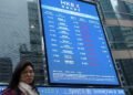 Stocks edge lower as dollar rises to one-year high
