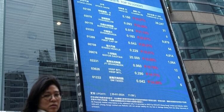 Stocks edge lower as dollar rises to one-year high