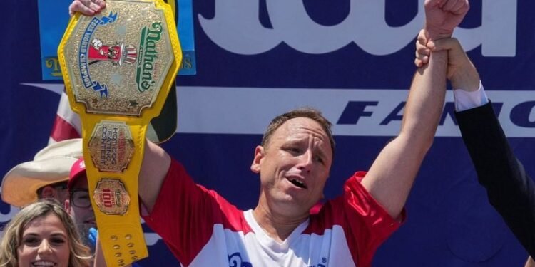 Eating champion Joey Chestnut defends title but blames heat for lower hot-dog tally